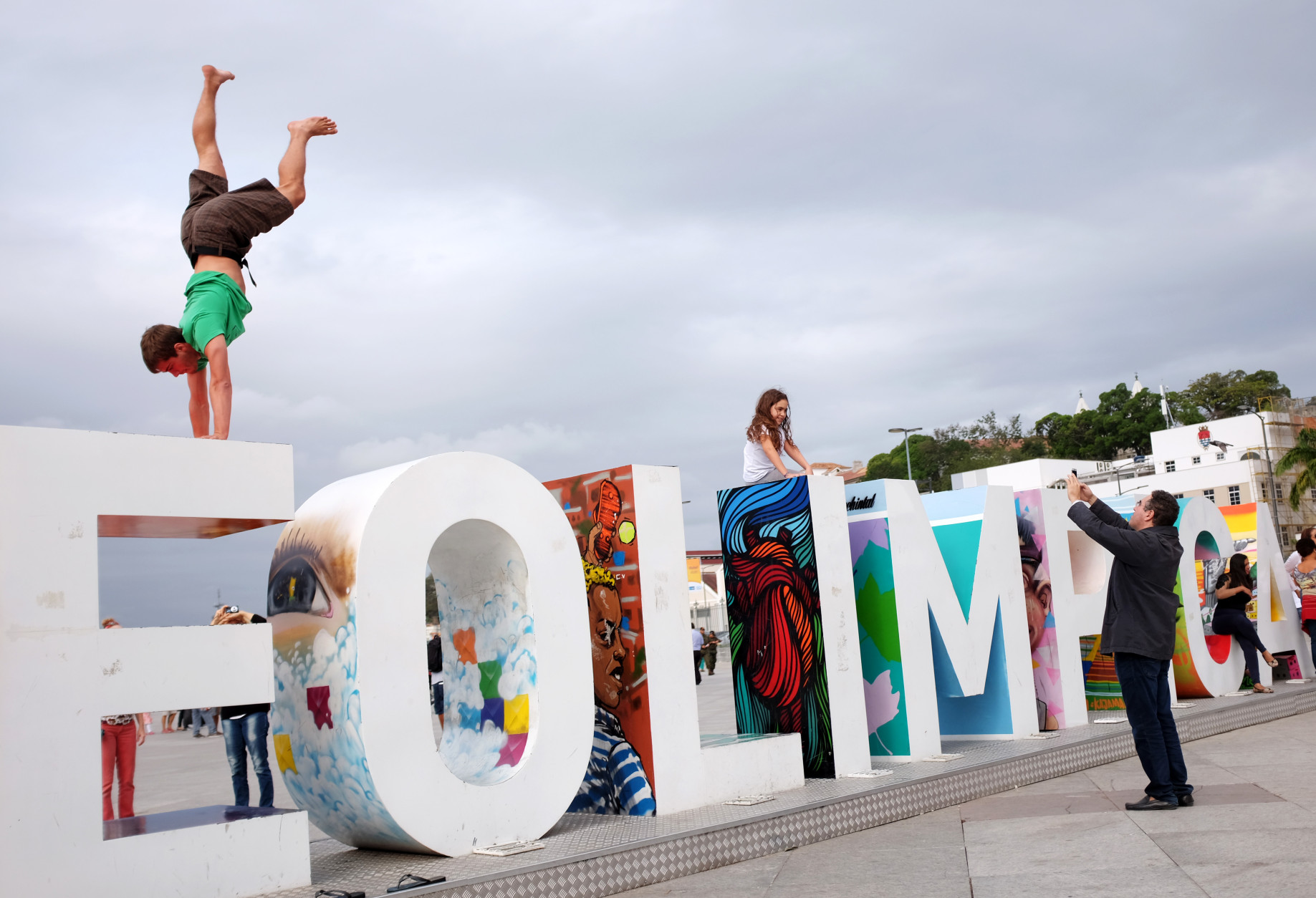 Yves Karrer, of Switzerland, does a handstand atop a sign the reads "Cidade Olimpica" or "Olympic City" outside the Museu do Amanha ahead of the upcoming 2016 Summer Olympics in Rio de Janeiro, Brazil, Wednesday, Aug. 3, 2016. (AP Photo/David Goldman)
