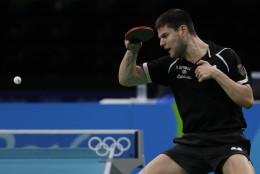 Germany's Dimitrij Ovtcharov throws a forehand during a table tennis training session ahead the 2016 Summer Olympics in Rio de Janeiro, Brazil, Wednesday, Aug. 3, 2016. (AP Photo/Petros Giannakouris)