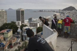 Boys look at kites atop the Babilonia slum, overlooking Copacabana beach in Rio de Janeiro, Brazil, Wednesday, Aug. 3, 2016. The Olympics are scheduled to open Aug. 5. (AP Photo/Felipe Dana)