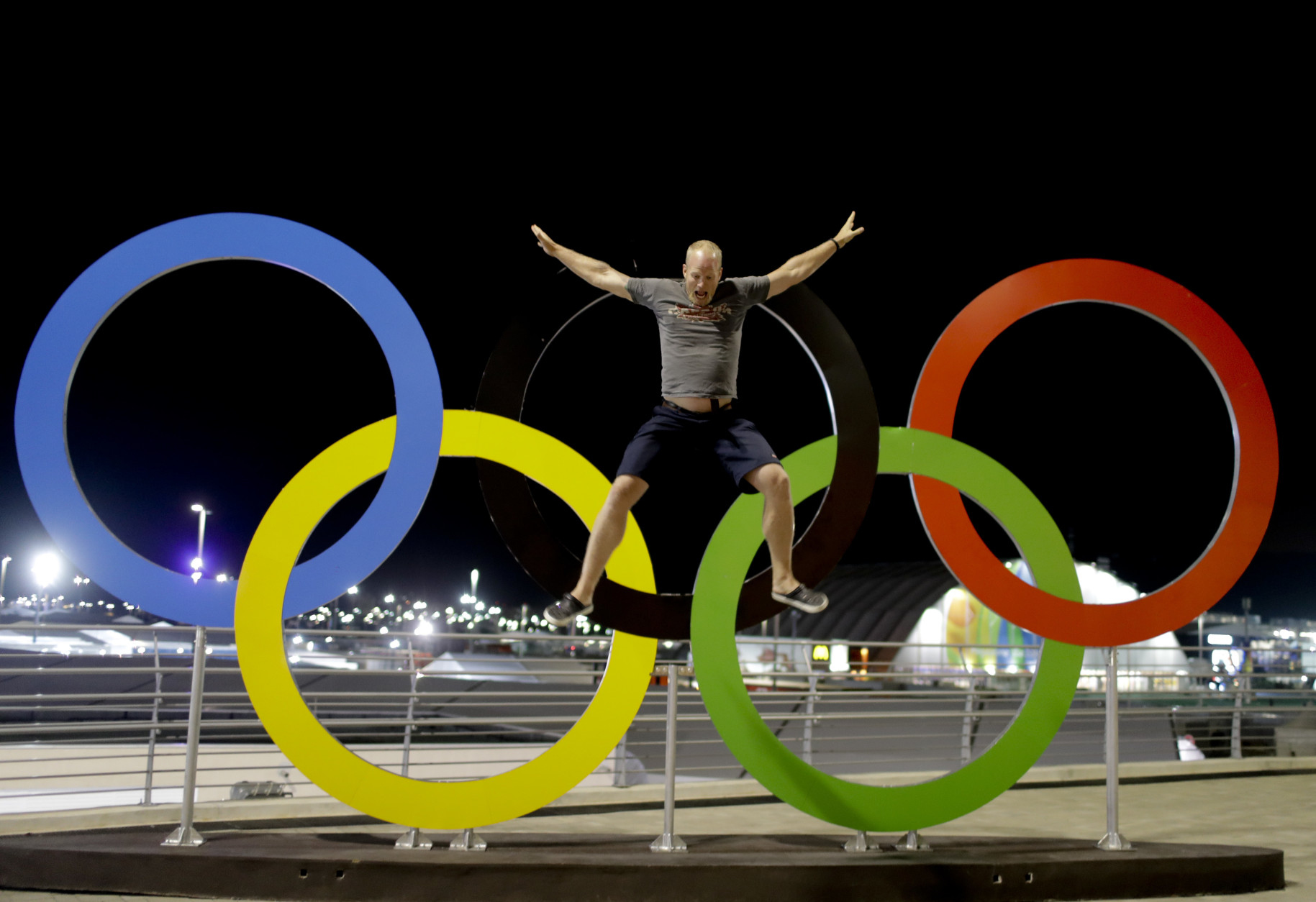 Adam Kreek jumps from the Olympic rings, while posing for a video, prior to the Summer Olympics in Rio de Janeiro, Brazil, Wednesday, Aug. 3, 2016. The Games opening ceremony is on Friday.(AP Photo/Natacha Pisarenko)