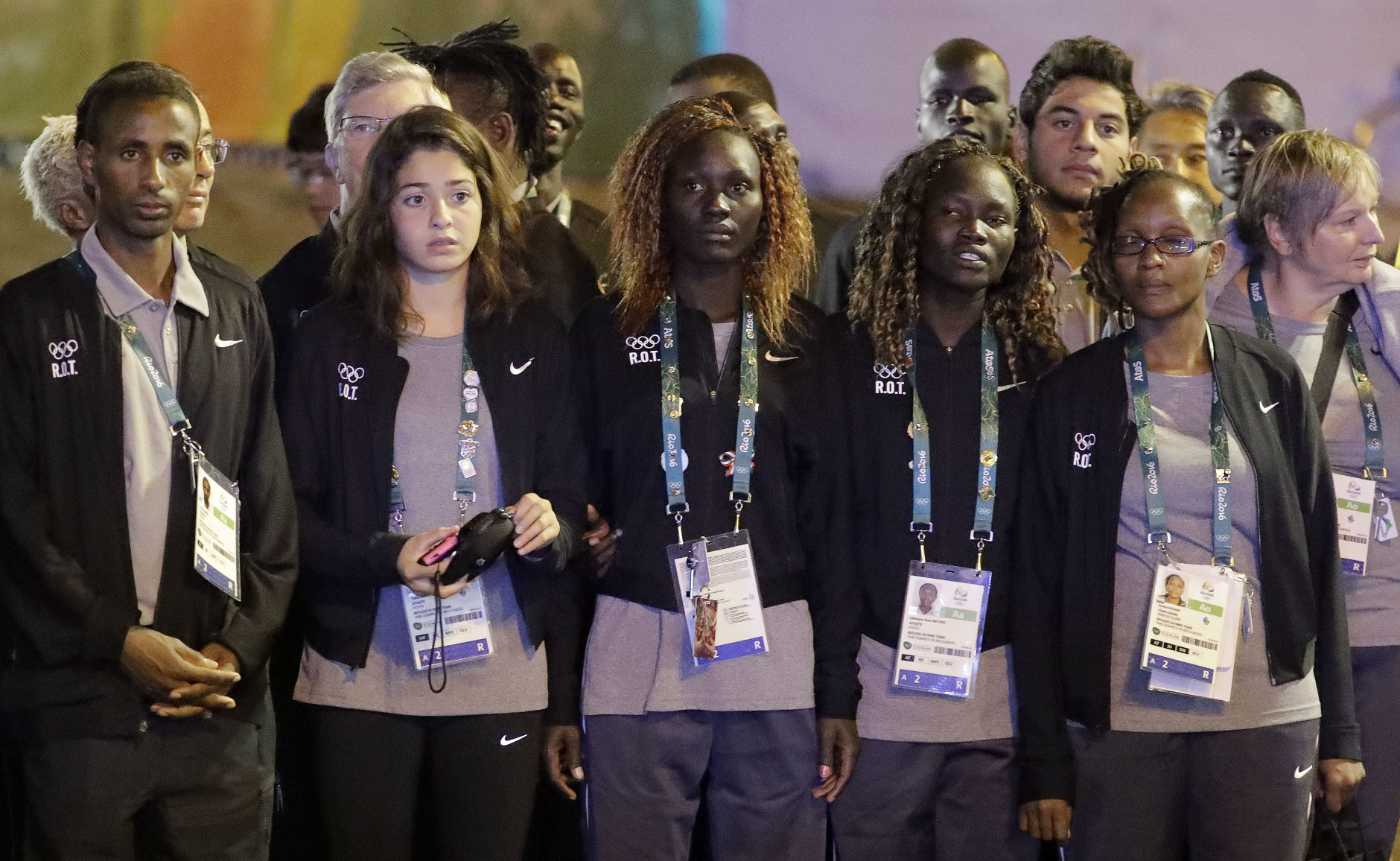 Members of the Refugee Olympic Team watch a performance during a welcome ceremony at the Olympic athletes village in Rio de Janeiro, Brazil, Wednesday, Aug. 3, 2016. The Summer 2016 Olympics is scheduled to open Aug. 5. (AP Photo/Charlie Riedel)
