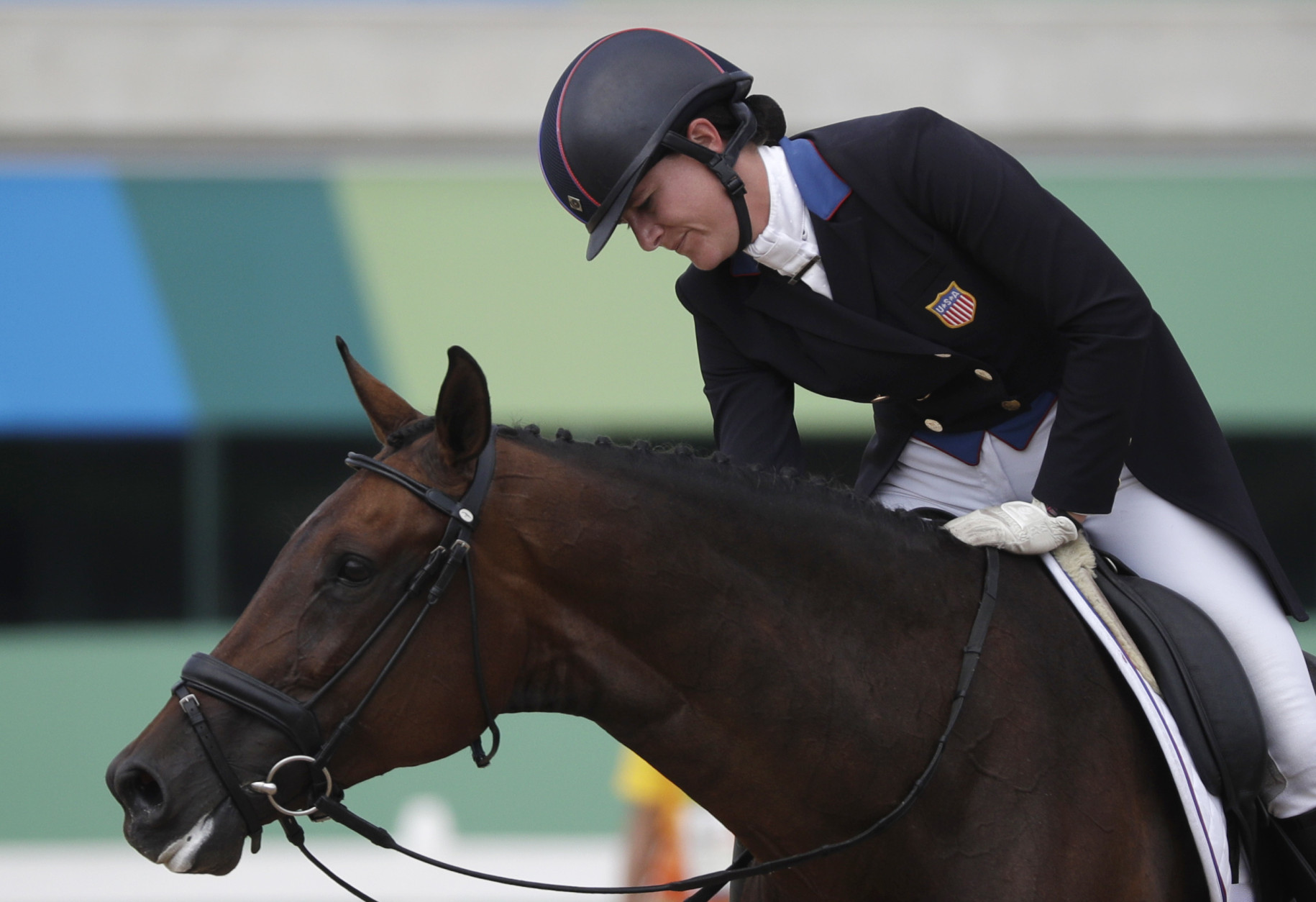 Lauren Kieffer, of the United States, reacts on Veronica after competing in the equestrian eventing dressage competition at the 2016 Summer Olympics in Rio de Janeiro, Brazil, Sunday, Aug. 7, 2016. (AP Photo/John Locher)
