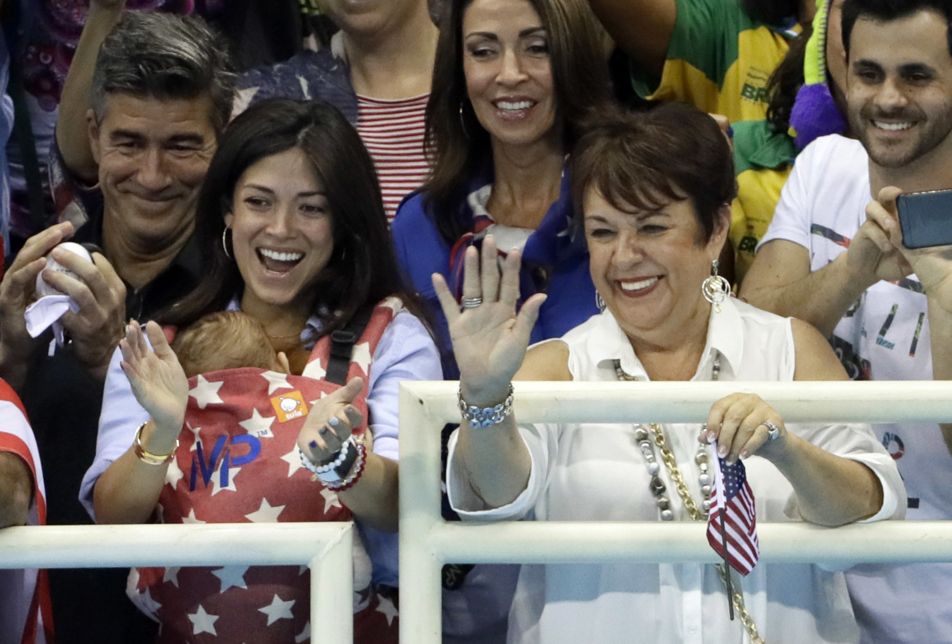 The family of United States' Michael Phelps, mother Debbie, right, and his fiance Nicole Johnson holding their baby Boomer during the swimming competitions at the 2016 Summer Olympics, Monday, Aug. 8, 2016, in Rio de Janeiro, Brazil. (AP Photo/David J. Phillip)