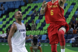 China's Guo Ailun (6) drives to the basket past France's Tony Parker (9) during a basketball game at the 2016 Summer Olympics in Rio de Janeiro, Brazil, Monday, Aug. 8, 2016. (AP Photo/Charlie Neibergall)