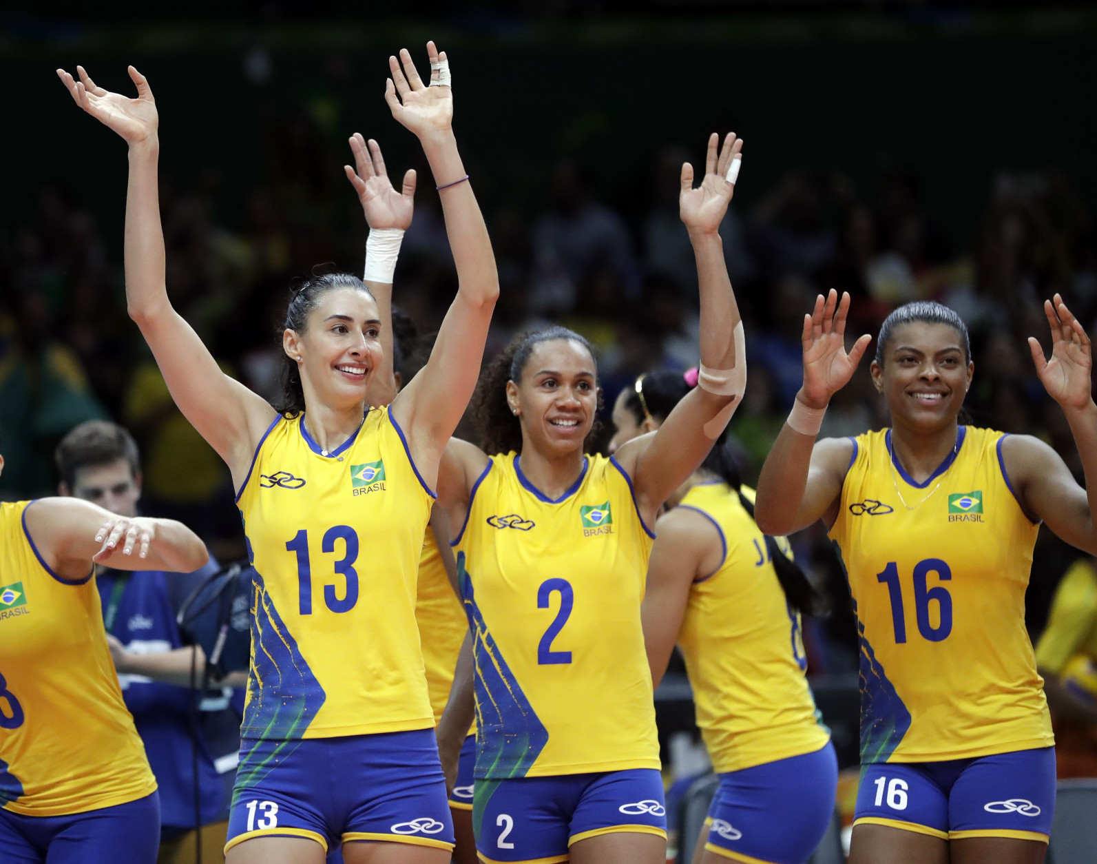 Team Brazil's Sheilla Castro de Paula Blassioli (13), Juciely Cristina Barreto (2) and Fernanda Rodrigues (16) wave to fans after defeating Argentina in a women's preliminary volleyball match at the 2016 Summer Olympics in Rio de Janeiro, Brazil, Tuesday, Aug. 9, 2016. (AP Photo/Jeff Roberson)