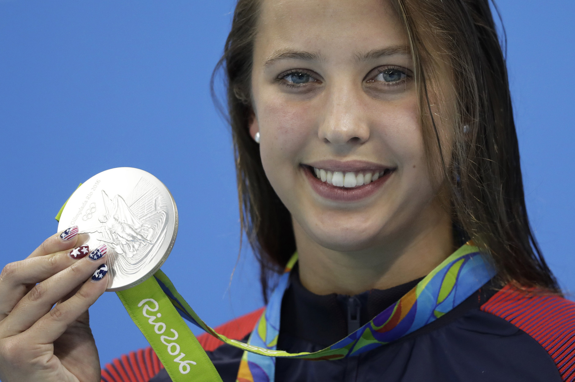 United States' Kathleen Baker shows off her silver medal during the ceremony for the women's 100-meter backstroke final during the swimming competitions at the 2016 Summer Olympics, Monday, Aug. 8, 2016, in Rio de Janeiro, Brazil. (AP Photo/Michael Sohn)