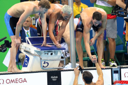 United States' Townley Haas, left, Ryan Lochte, center, and Conor Dwyer celebrate as Michael Phelps, in the pool, finishes to win the gold medal in the men's 4x200-meter freestyle final during the swimming competitions at the 2016 Summer Olympics, Tuesday, Aug. 9, 2016, in Rio de Janeiro, Brazil. (AP Photo/Lee Jin-man)