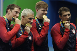 The United States team from left, Conor Dwyer, Ryan Lochte, Townley Haas and Michael Phelps celebrate with their gold medals after the men's 4x200-meter freestyle relay during the swimming competitions at the 2016 Summer Olympics, Wednesday, Aug. 10, 2016, in Rio de Janeiro, Brazil. (AP Photo/Matt Slocum)