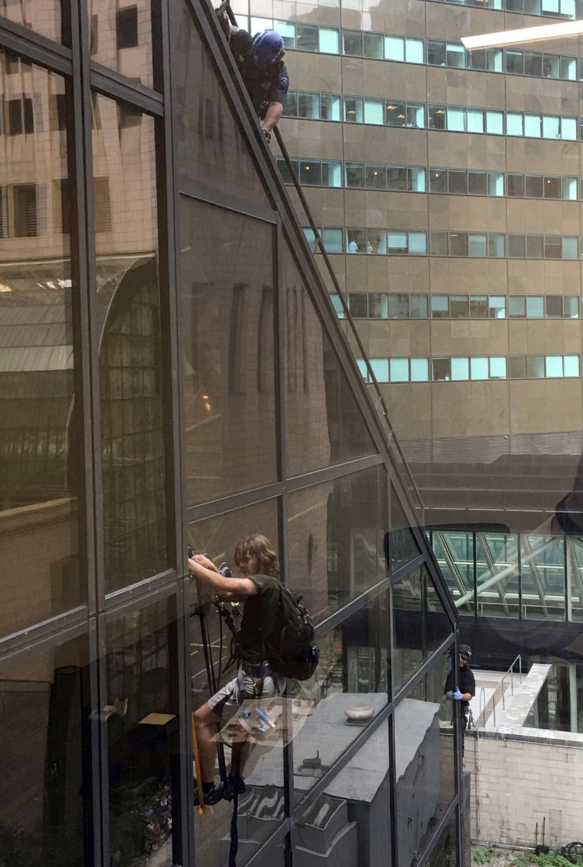 A man scales the all-glass face of Trump Tower in New York, Wednesday, Aug. 10, 2016. The 58-story building is headquarters to the Republican presidential nominee's campaign. He also lives there. (Alex Cannon via AP)