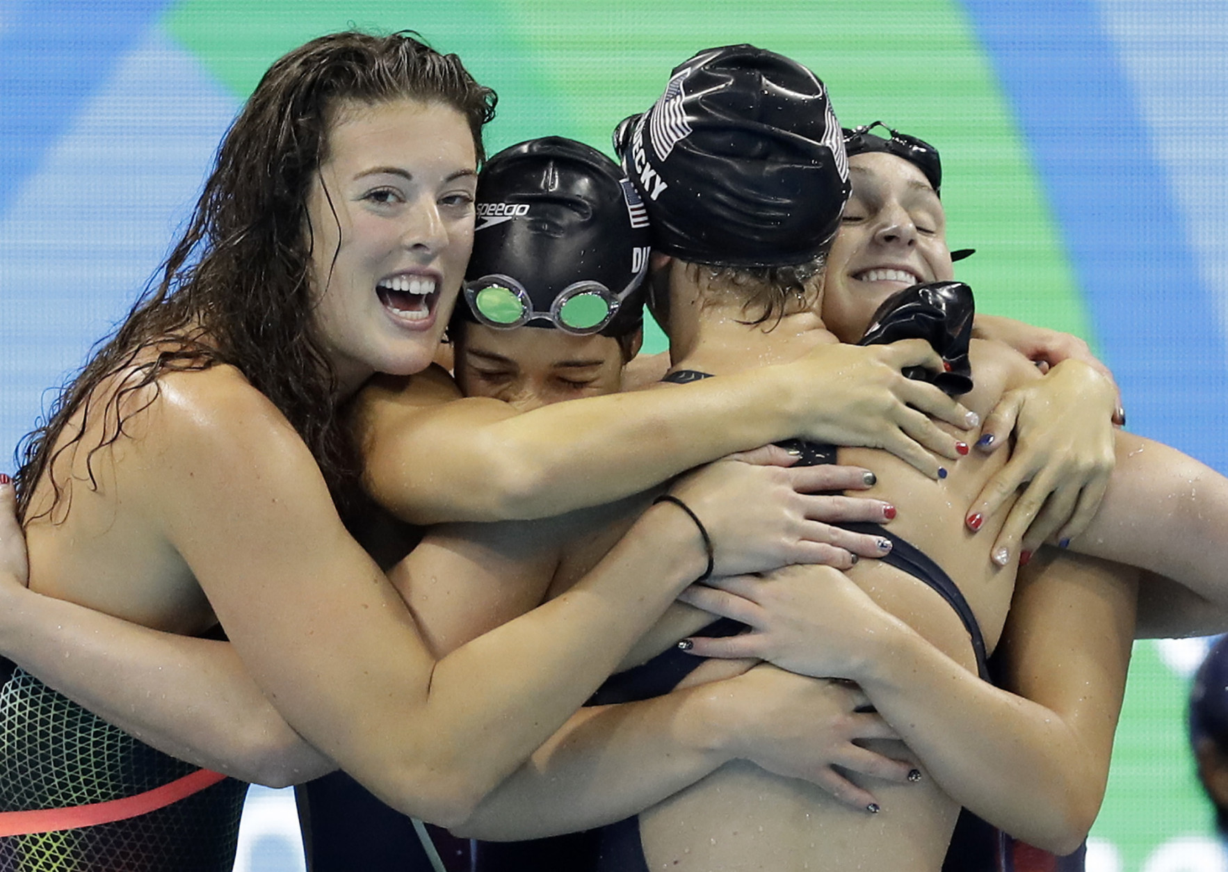 United States' Katie Ledecky, second from right, celebrates with her teammates Allison Schmitt, Maya DiRado and Leah Smith, from left, after coming in first in the women's 4 x 200-meter freestyle relay final during the swimming competitions at the 2016 Summer Olympics, Thursday, Aug. 11, 2016, in Rio de Janeiro, Brazil. (AP Photo/Michael Sohn)