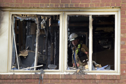 Emergency personnel investigate the inside of an apartment building following a fire in Silver Spring, Md., Thursday, Aug. 11, 2016. At least two people died and dozens, including three firefighters, were injured after an explosion and large fire at the apartment complex. (AP Photo/Susan Walsh)