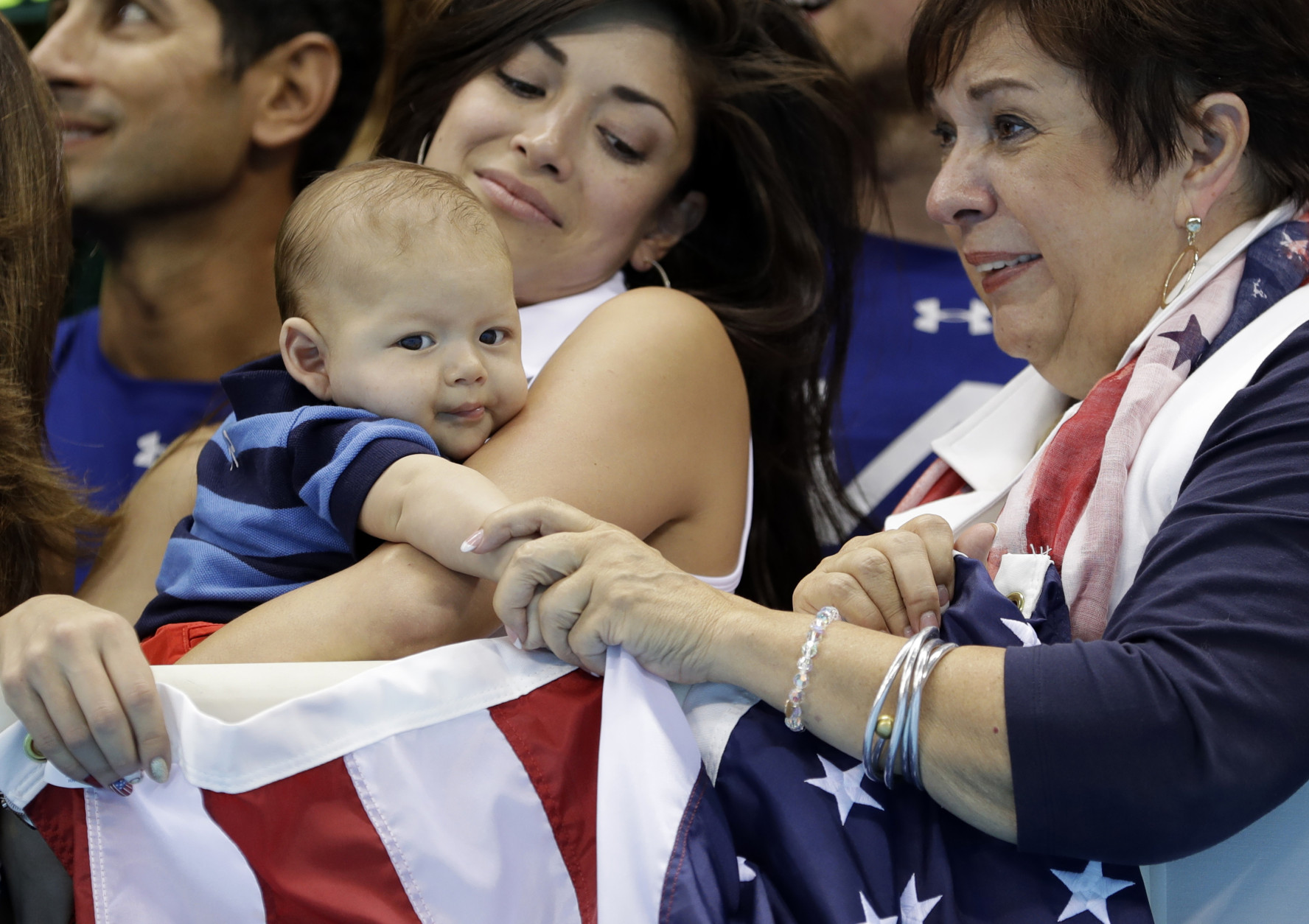 Nicole Johnson, fiance of United States' Michael Phelps, holds their baby Boomer, as she stands with Phelps' mother Debbie during the men's 4 x 100-meter medley relay final during the swimming competitions at the 2016 Summer Olympics, Saturday, Aug. 13, 2016, in Rio de Janeiro, Brazil. (AP Photo/Michael Sohn)