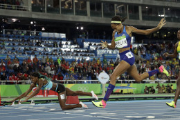 Bahamas' Shaunae Miller falls over the finish line to win gold ahead of United States' Allyson Felix, right, in the women's 400-meter final during the athletics competitions of the 2016 Summer Olympics at the Olympic stadium in Rio de Janeiro, Brazil, Monday, Aug. 15, 2016. (AP Photo/Matt Slocum)