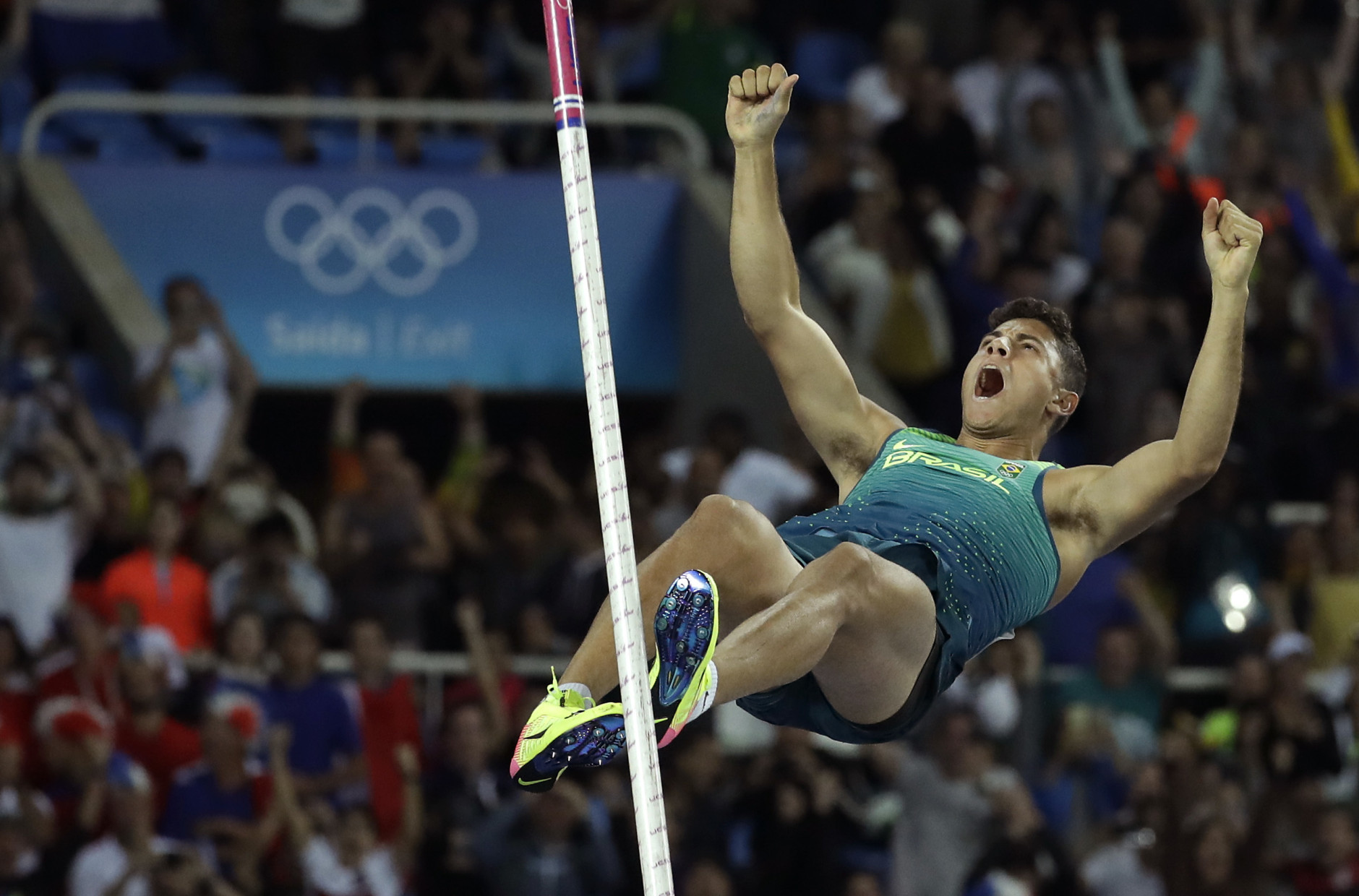 Brazil's Thiago Braz Da Silva celebrates after clearing the bar to set new Olympic record during the athletics competitions of the 2016 Summer Olympics at the Olympic stadium in Rio de Janeiro, Brazil, Tuesday, Aug. 16, 2016. (AP Photo/Matt Dunham)