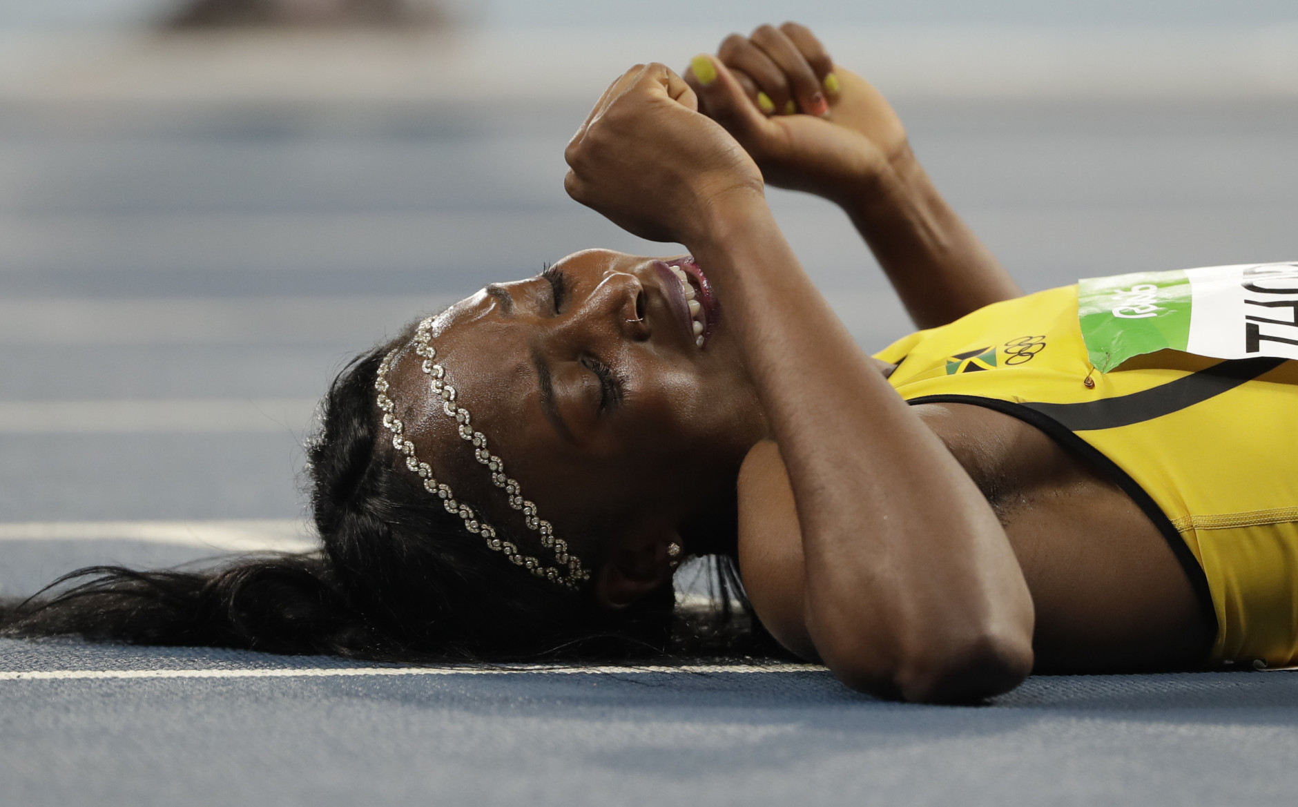 Elaine Thompson from Jamaica celebrates winning the gold medal in the women's 200-meter final during the athletics competitions of the 2016 Summer Olympics at the Olympic stadium in Rio de Janeiro, Brazil, Wednesday, Aug. 17, 2016. (AP Photo/David J. Phillip)