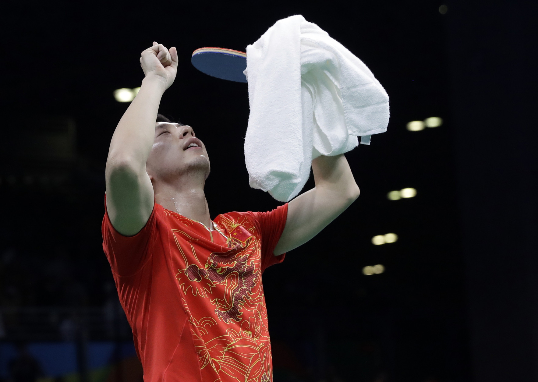China's Ma Long celebrates after defeating Japan's Maharu Yoshimura in a singles match to win the gold medal for China in the men's team table tennis competition at the 2016 Summer Olympics in Rio de Janeiro, Brazil, Wednesday, Aug. 17, 2016. (AP Photo/Petros Giannakouris)