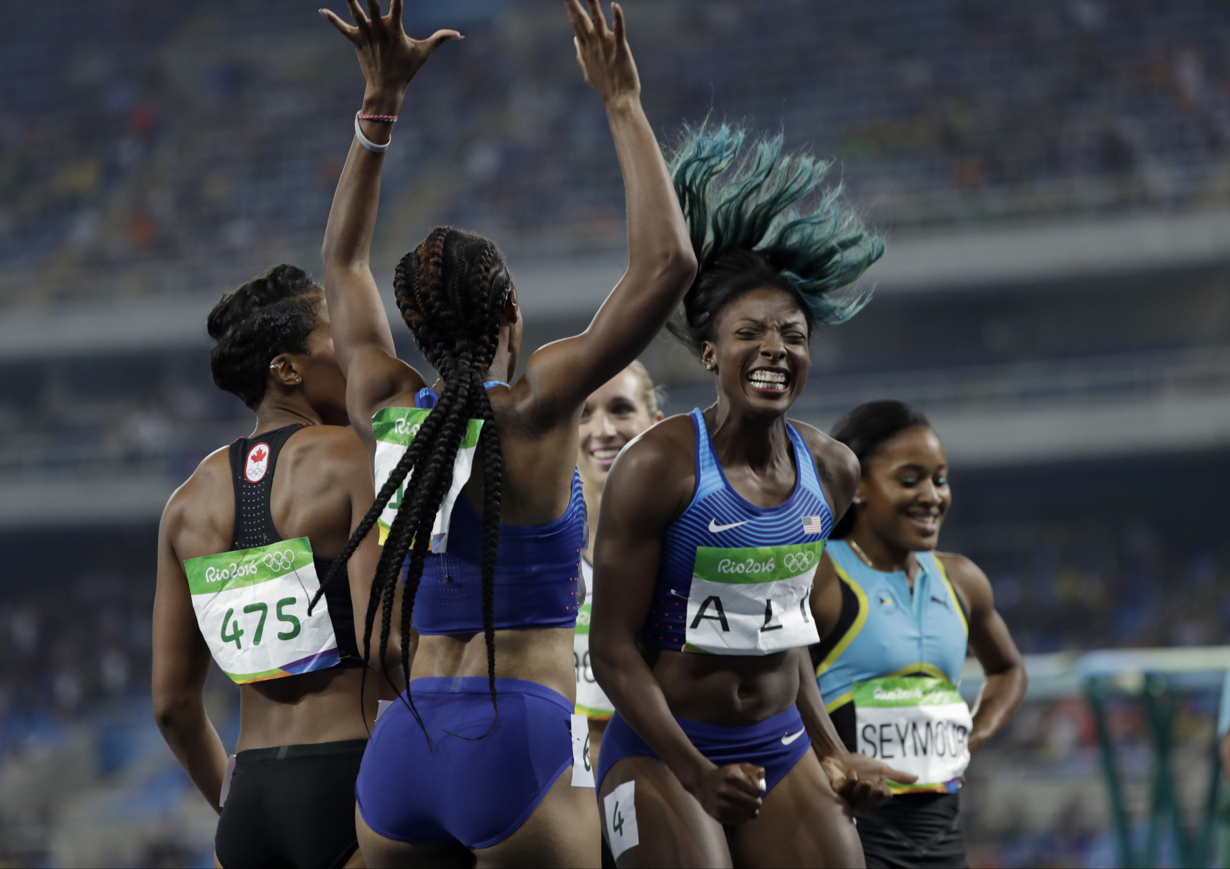 Brianna Rollins from the United States, center left, celebrates winning the gold medal in the women's 100-meter hurdles final with second placed United States' Nia Ali, center right, during the athletics competitions of the 2016 Summer Olympics at the Olympic stadium in Rio de Janeiro, Brazil, Wednesday, Aug. 17, 2016. (AP Photo/David J. Phillip)