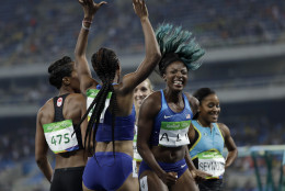 Brianna Rollins from the United States, center left, celebrates winning the gold medal in the women's 100-meter hurdles final with second placed United States' Nia Ali, center right, during the athletics competitions of the 2016 Summer Olympics at the Olympic stadium in Rio de Janeiro, Brazil, Wednesday, Aug. 17, 2016. (AP Photo/David J. Phillip)