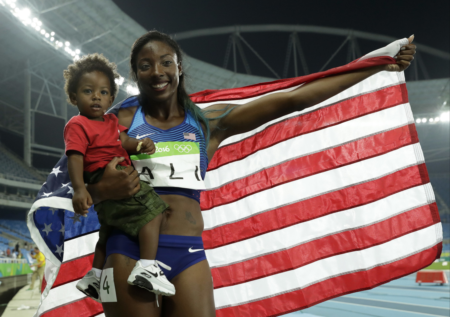 United States' silver medal winner Nia Ali poses with her 15-months old son Titus after the women's 100-meter hurdles final, during the athletics competitions of the 2016 Summer Olympics at the Olympic stadium in Rio de Janeiro, Brazil, Wednesday, Aug. 17, 2016. (AP Photo/Matt Dunham)
