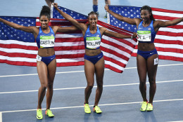 Gold medal winner United States' Brianna Rollins, center, silver medal winner United States' Nia Ali, right, and bronze medal winner United States' Kristi Castlin celebrate after the women's 100-meter hurdles final during the athletics competitions of the 2016 Summer Olympics at the Olympic stadium in Rio de Janeiro, Brazil, Wednesday, Aug. 17, 2016. (AP Photo/Martin Meissner)