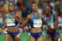 Gold medal winner Brianna Rollins, center, silver medal winner, Nia Ali, right, and bronze medal winner Kristi Castlin, all from the United States, pose with their country's flag after the 100-meter hurdles final,during the athletics competitions of the 2016 Summer Olympics at the Olympic stadium in Rio de Janeiro, Brazil, Wednesday, Aug. 17, 2016. (AP Photo/Lee Jin-man)