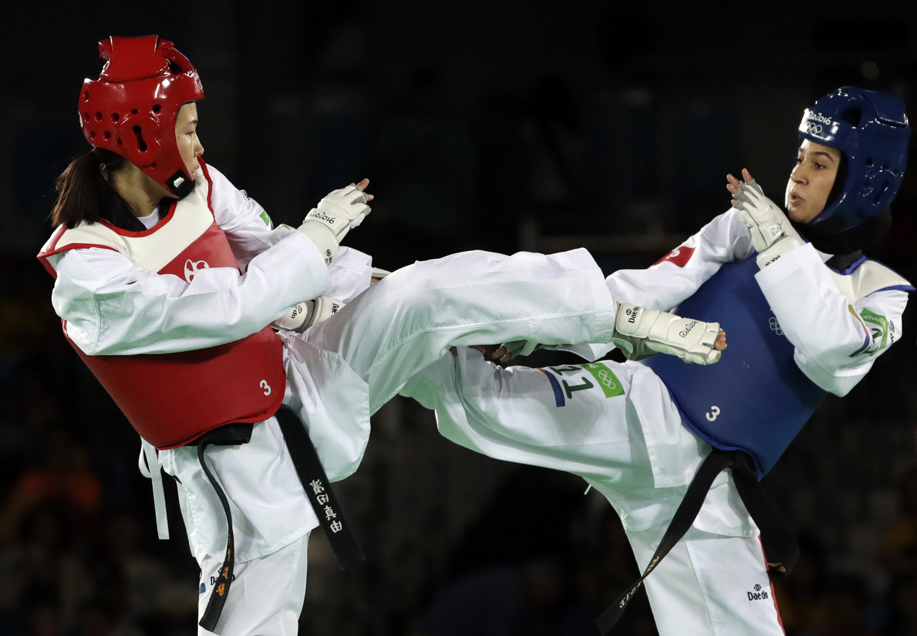 Rahma Bel Ali of Tunisia, right, and Hamada Mayu of Japan compete in a women's Taekwondo 57-kg event at the 2016 Summer Olympics in Rio de Janeiro, Brazil, Thursday, Aug. 18, 2016. (AP Photo/Andrew Medichini)
