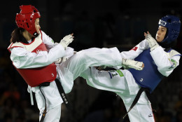 Rahma Bel Ali of Tunisia, right, and Hamada Mayu of Japan compete in a women's Taekwondo 57-kg event at the 2016 Summer Olympics in Rio de Janeiro, Brazil, Thursday, Aug. 18, 2016. (AP Photo/Andrew Medichini)