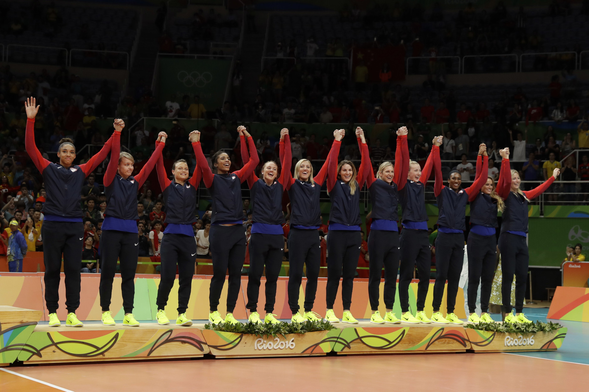 Members of the United States team take the stand to receive their bronze medals during an awarding ceremony for women's volleyball at the 2016 Summer Olympics in Rio de Janeiro, Brazil, Sunday, Aug. 21, 2016. (AP Photo/Matt Rourke)