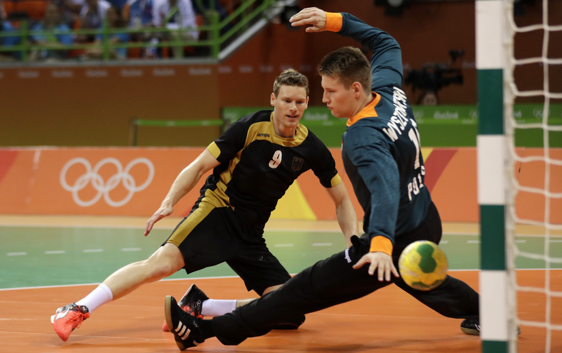 Germany's Tobias Reichmann scores a goal past Poland's Piotr Wyszomirski, right, during the men's bronze medal handball match between Germany and Poland at the 2016 Summer Olympics in Rio de Janeiro, Brazil, Sunday, Aug. 21, 2016. (AP Photo/Ben Curtis)