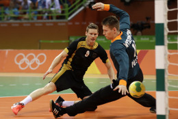 Germany's Tobias Reichmann scores a goal past Poland's Piotr Wyszomirski, right, during the men's bronze medal handball match between Germany and Poland at the 2016 Summer Olympics in Rio de Janeiro, Brazil, Sunday, Aug. 21, 2016. (AP Photo/Ben Curtis)