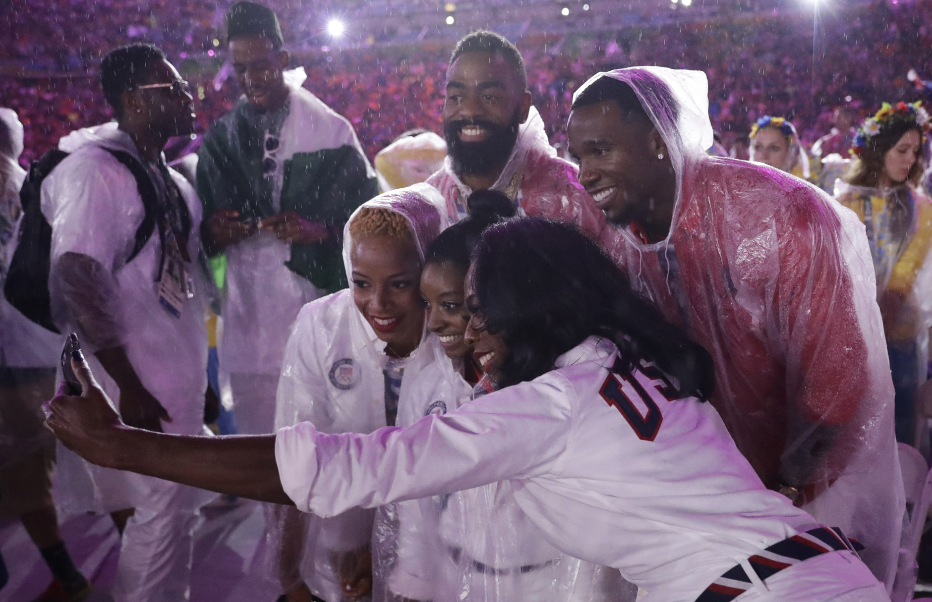 Athletes from the United States pose for a photo with Simone Biles during the closing ceremony in the Maracana stadium at the 2016 Summer Olympics in Rio de Janeiro, Brazil, Sunday, Aug. 21, 2016. (AP Photo/Matt Dunham)