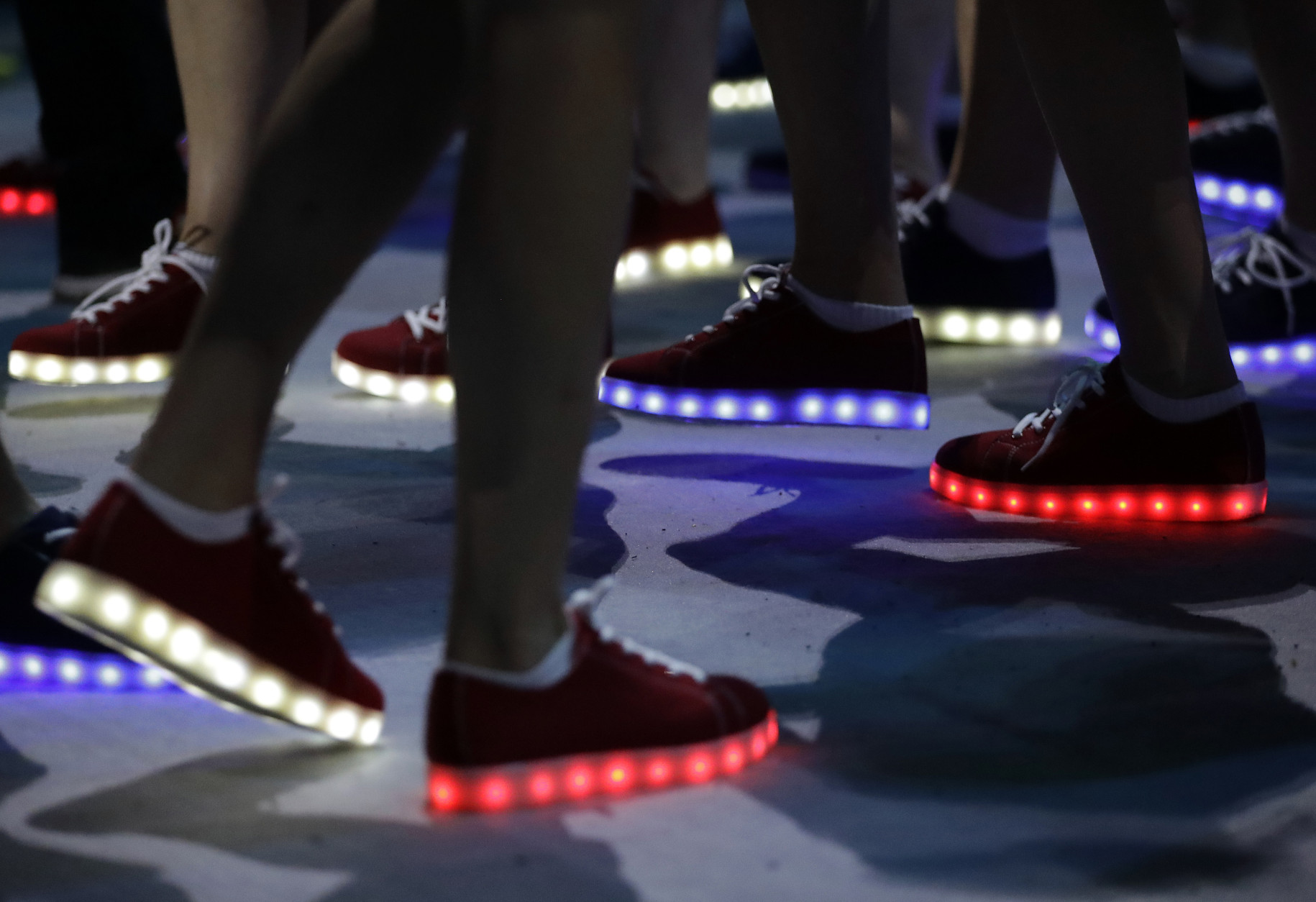 British athletes wear glooming shoes during the closing ceremony in the Maracana stadium at the 2016 Summer Olympics in Rio de Janeiro, Brazil, Sunday, Aug. 21, 2016. (AP Photo/David Goldman)