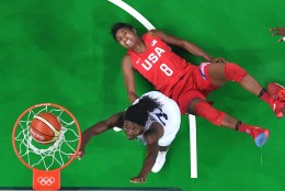 United States' Angel McCoughtry (8) falls to the floor as her shot over France's Laetitia Kamba, left, falls through the basket during a women's semifinals basketball game at the 2016 Summer Olympics in Rio de Janeiro, Brazil, Thursday, Aug. 18, 2016. (Andrej Isakovic/Pool Photo via AP)