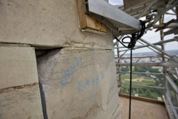 A missing corner of a stone is seen in the Washington Monument at the 491-foot level of the scaffolding surrounding the monument, Sunday, June 2, 2013 in Washington. The monument has been closed since the 2011 earthquake and half of the needed repairs have been funded by a $7.5 million donation from philanthropist David Rubenstein. The Associated Press had a look at some of the worst damage and the preparations underway to begin making repairs. Stone by stone, engineers are reviewing cracks, missing pieces and broken mortar now that huge scaffolding has been built around the towering symbol of the nations capital. Once each trouble spot is identified, repairs can begin.  (AP Photo/Alex Brandon)