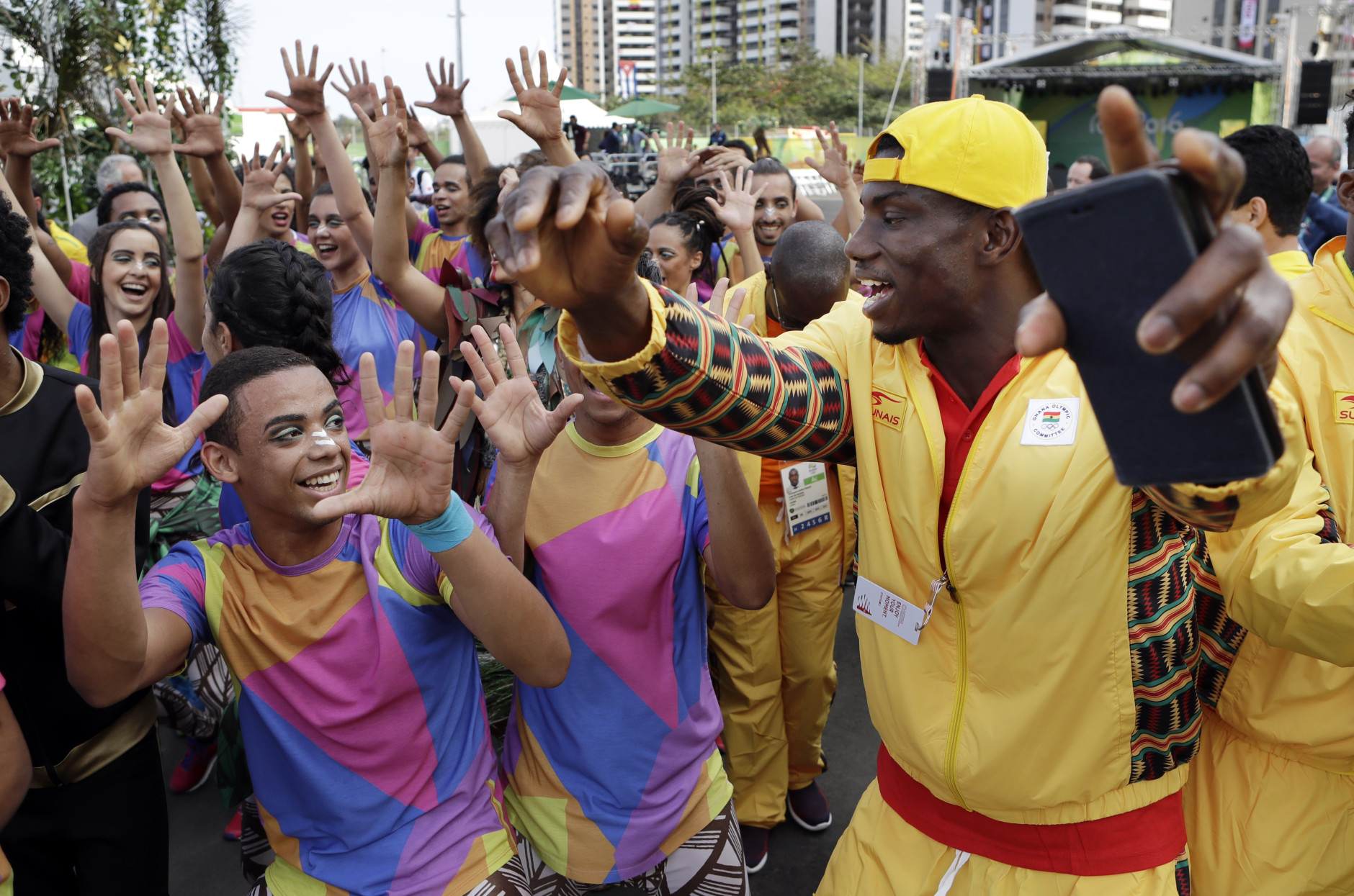 An athlete from Ghana dances with Brazilian performers at a welcoming ceremony at the 2016 Summer Olympics in Rio de Janeiro, Brazil, Wednesday, Aug. 3, 2016. (AP Photo/Robert F. Bukaty)