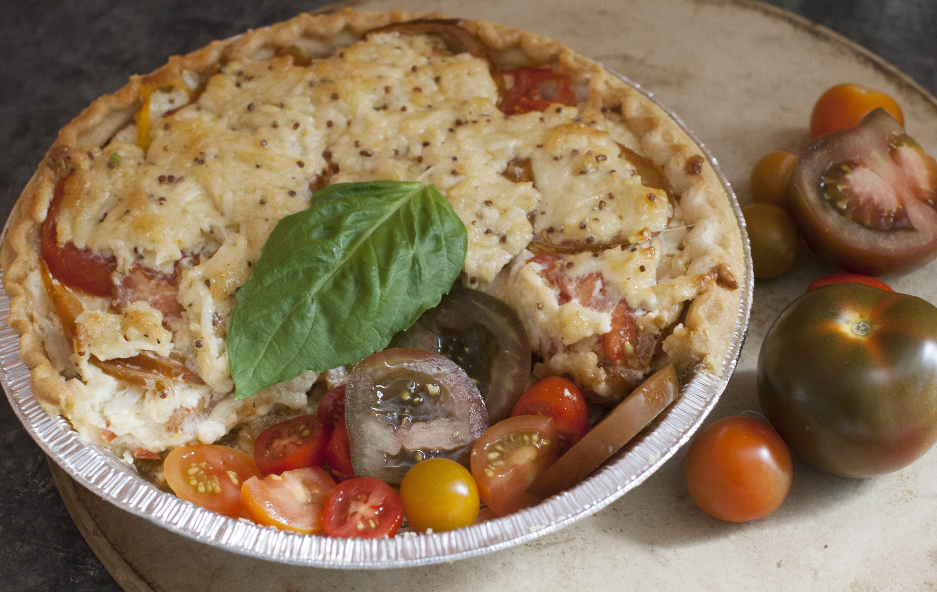 This June 9, 2014 photo shows Dijon tomato and sweet onion pie in Concord, N.H. The Tomato Pie is a classic Southern dish made in summer when the tomato plants are heavy with ripe fruit. (AP Photo/Matthew Mead)