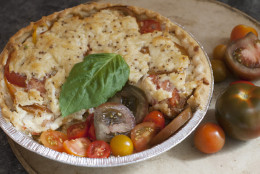 This June 9, 2014 photo shows Dijon tomato and sweet onion pie in Concord, N.H. The Tomato Pie is a classic Southern dish made in summer when the tomato plants are heavy with ripe fruit. (AP Photo/Matthew Mead)
