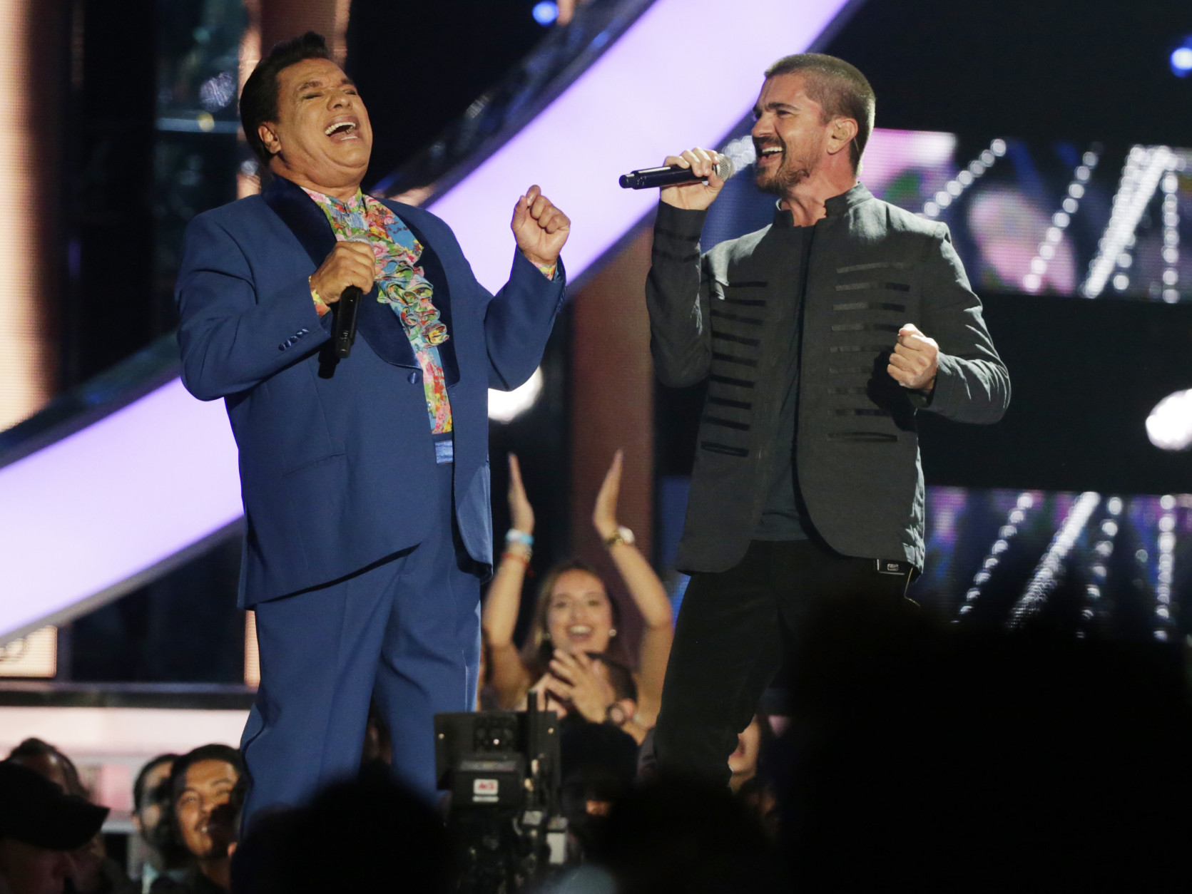 Singers Juan Gabriel, left, and Juanes, perform a song together during the Latin Billboard Awards, Thursday, April 28, 2016 in Coral Gables, Fla. (AP Photo/Wilfredo Lee)