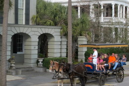 In this Dec. 28, 2014 photo, a carriage pauses in the historic district in in Charleston, S.C. Low gas prices, a thriving economy and renewed consumer confidence are expected to mean a banner season in 2015 for South Carolina's tourism industry. (AP Photo/Bruce Smith)