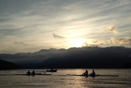 Rowers are silhouetted against the mountains as the sun rises in Deep Cove in North Vancouver, British Columbia, Tuesday, June 3, 2014. (AP Photo/The Canadian Press, Jonathan Hayward)