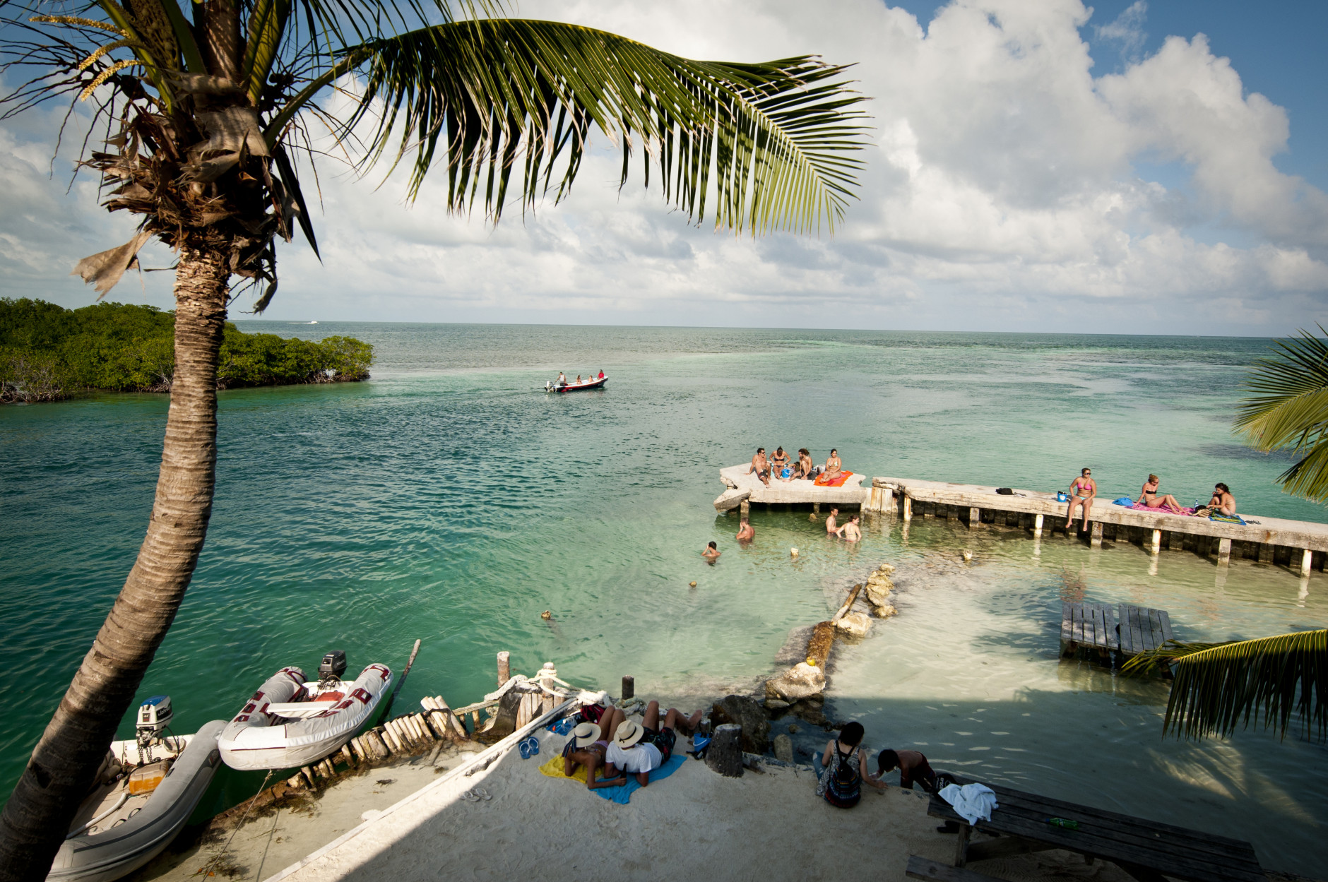 This undated photo provided by The Belize Tourism Board shows vacationers relaxing at Caye Caulker, Belize. The beach town is a laid-back, low-cost base for tourists looking to explore a nearby barrier reef. (AP Photo/The Belize Tourist Board)