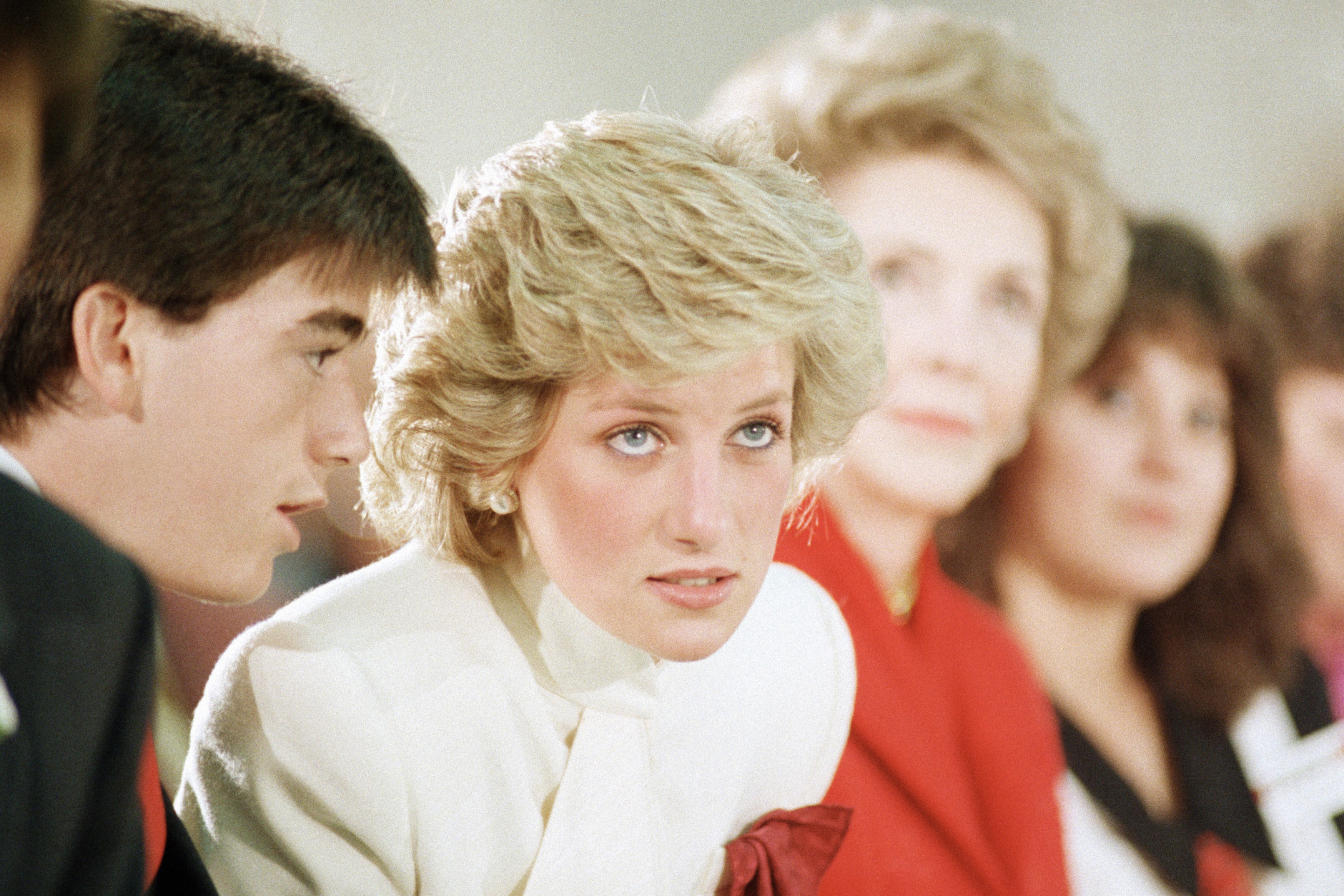 Diana, Princess of listens to Mike Kirsch, a member of Straight Inc. explain the procedure a 45-minute rap session as first lady Nancy Reagan, right, looks on at the drug center in Springfield, Va., on Monday, Nov. 11, 1985. (AP Photo/Ron Edmonds)
