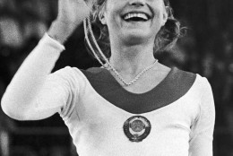 The gymnastics individual event at the summer Olympics in Munich gave the gold medal to 15-year-old Olga Korbut, USSR, pictured here with her gold medal on Aug. 31, 1972. (AP Photo/Pool)