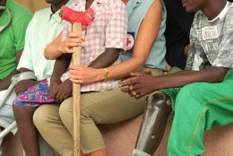 Diana, Princess of Wales, talks to amputees, Tuesday January 14, 1997, at the the Neves Bendinha Orthopedic Workshop in the outskirts of Luanda. Sitting on Diana's lap is 13-year-old Sandra Thijica who lost her left leg to a land-mine while working the land with her mother in Saurimo, eastern Angola, in 1994. Princess Diana is visiting Angola in an effort to create awareness about land-mines. (AP Photo/Joao Silva)
