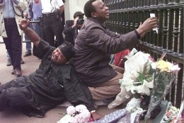 Two men grieve at the gate of Buckingham Palace in London  Sunday, August 31, 1997 after laying flowers for Diana, Princess of Wales, who was killed in a car crash with her comapnion Dodi Fayed in Paris early Sunday morning.  (AP Photo/Lynne Sladky)