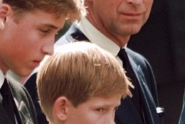 The Prince of Wales casts a concerned glance towards his sons Prince William (left) and Prince Harry as they wait for the coffin of Princess Diana to be loaded into a hearse outside of Westminster Abbey, Saturday, Sept. 6, 1997, in London. (AP Photo/John Gaps III)POOL
