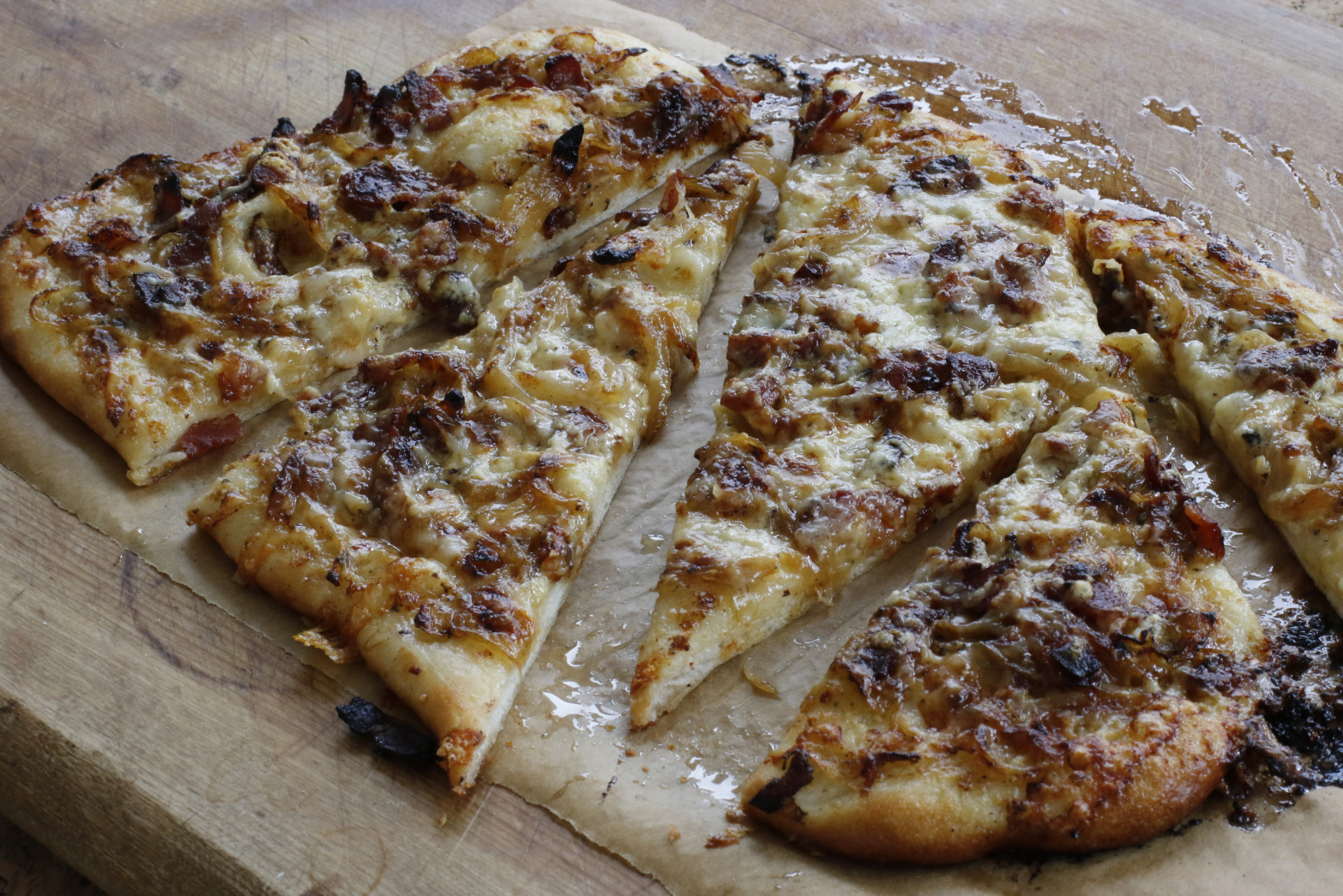 This March 2, 2016 photo shows Alsatian onion pie in Concord, N.H. This simple pizza-like dish gets a tremendous amount of flavor from onions, which are cooked slowly in a small amount of bacon fat. (AP Photo/J.M. Hirsch)