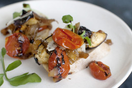 This July 21, 2014 photo shows tangy tomato-eggplant crostini in Concord, N.H. Salting and draining the eggplants and tomatoes removes excess water, which not only makes for a meatier texture, it also concentrates the flavors. (AP Photo/Matthew Mead)