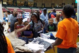 Attendees pick up clothes during the Prince George's County Back to School Fair on Saturday, Aug. 6, 2016. (WTOP/Allison Keyes)