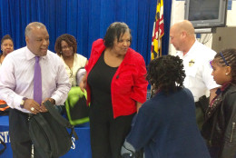 Prince George's County Executive Rushern Baker hands out school supplies to students at Suitland Elementary School on Tuesday, Aug. 23, 2016. The county's Department of Corrections hosts the free school supplies event to create a positive connection between young people and law enforcement and to help motivate students to stay out of trouble. (WTOP/Nick Iannelli)
